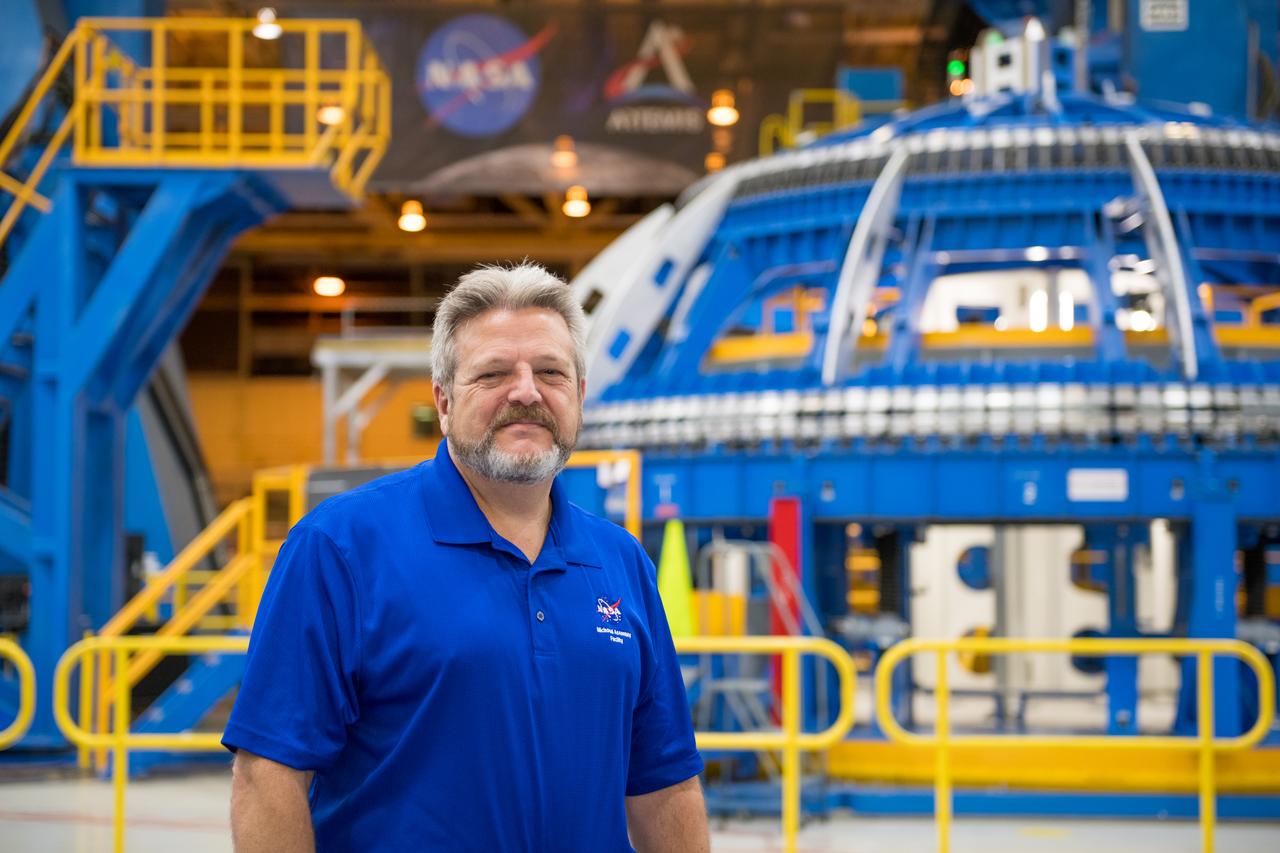 Robert Champion - Director NASA Michoud Assembly Facility stands in front of the Robotic Weld tool in BLDG 103.